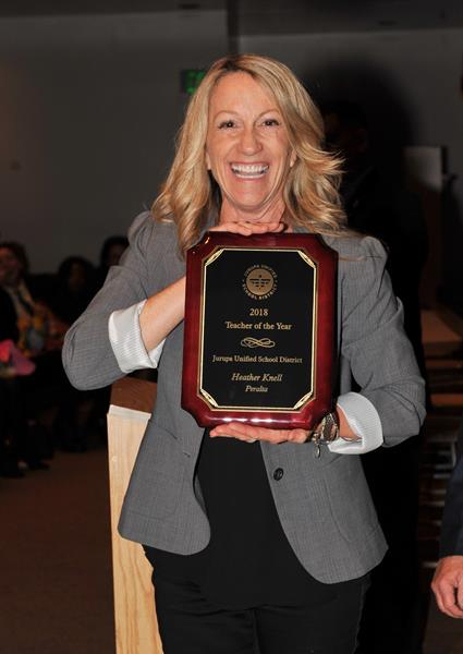 Heather Knell standing with plaque