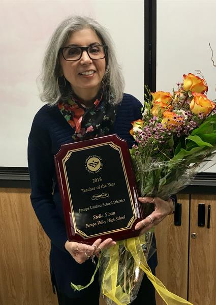 Stella Sloan standing with award and flowers