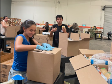 Students preparing boxes at a service event