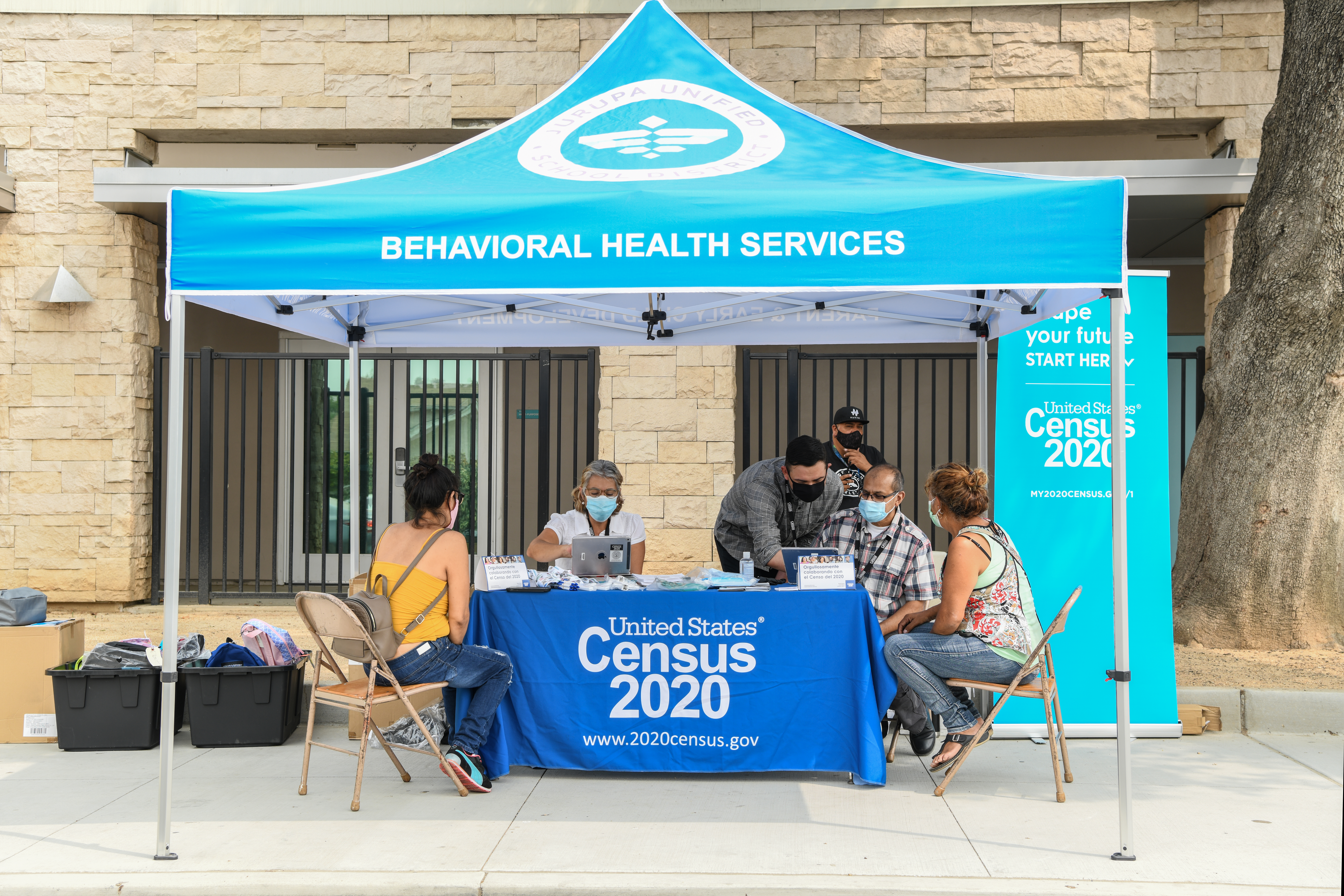 A mobile census unit helps families fill out the 2020 Census