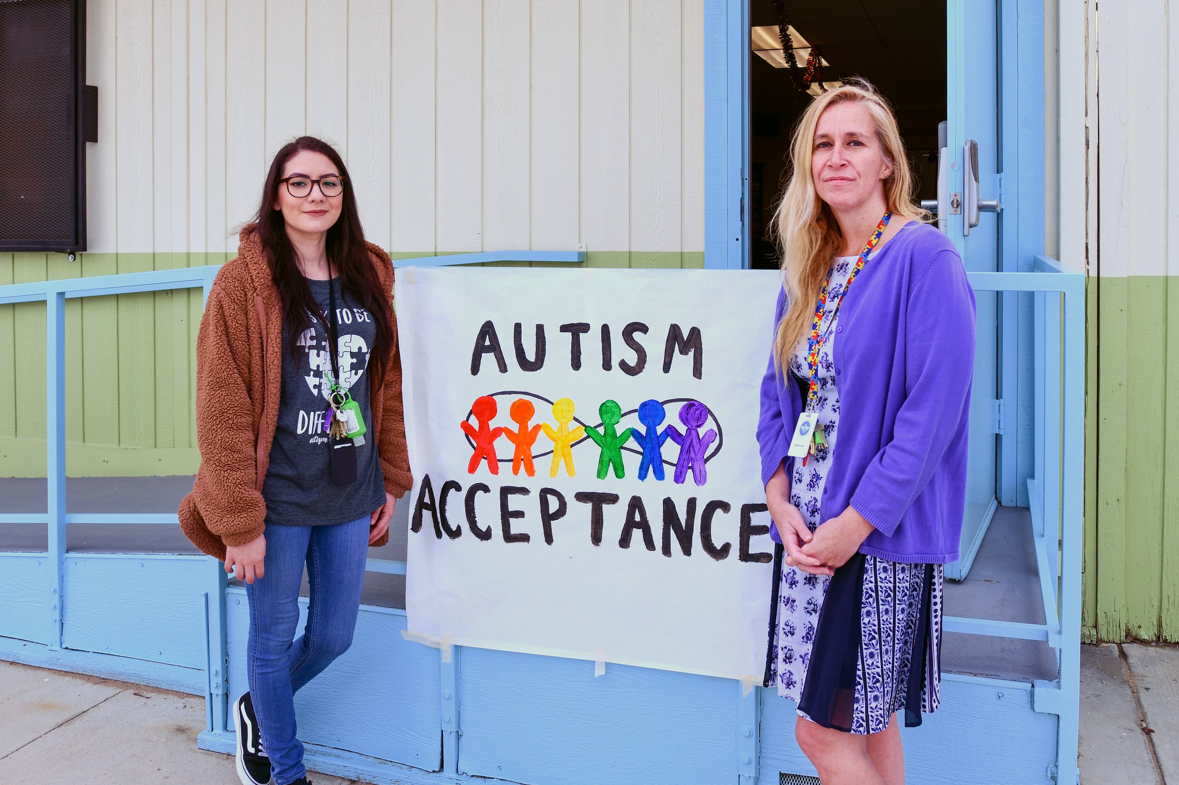 Cera and Suzanne in front of autism acceptance poster