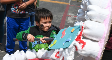 Child plays toothbrushing game at fair