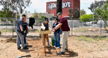Mr. Horton teaches CSI students how to sift dirt