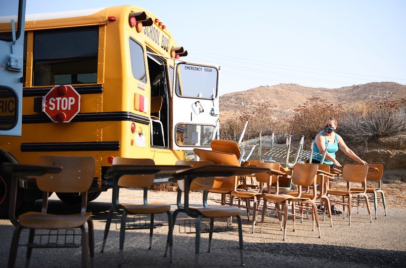 Desks lined up beside a school bus