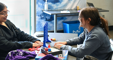 Two students playing Connect 4 in the Wellness Center