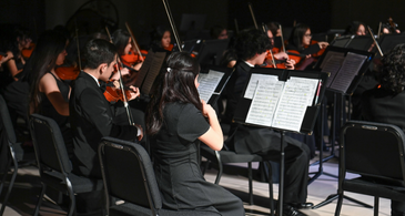 Orchestra students performing in the concert hall