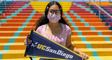 Kylie Carmona holding UCSD Pennant