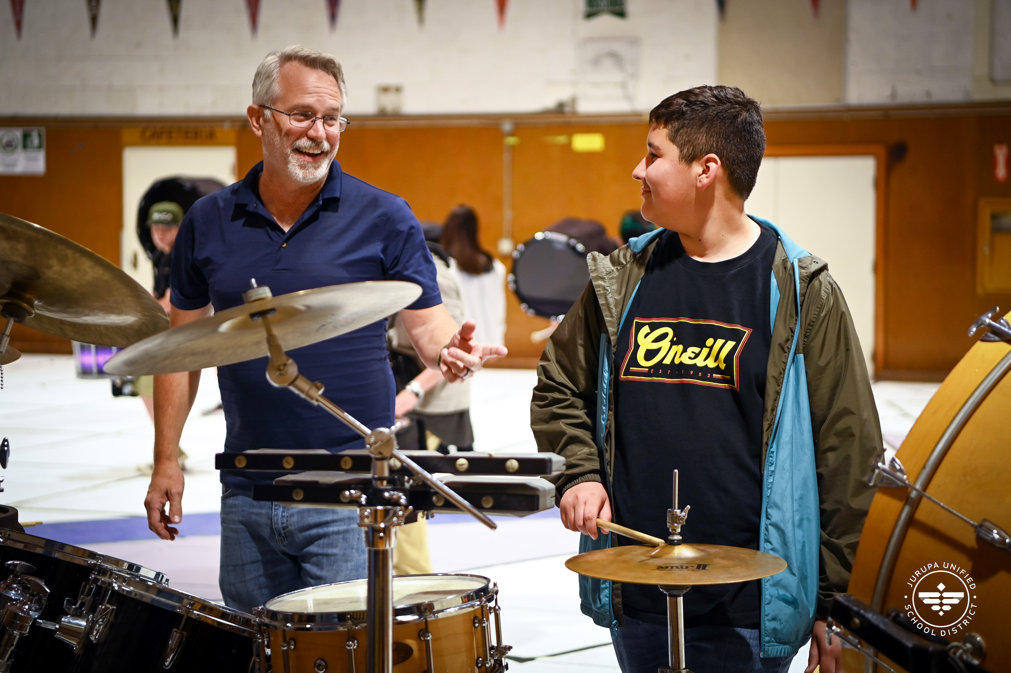 Jay Hakomaki with a drumline student