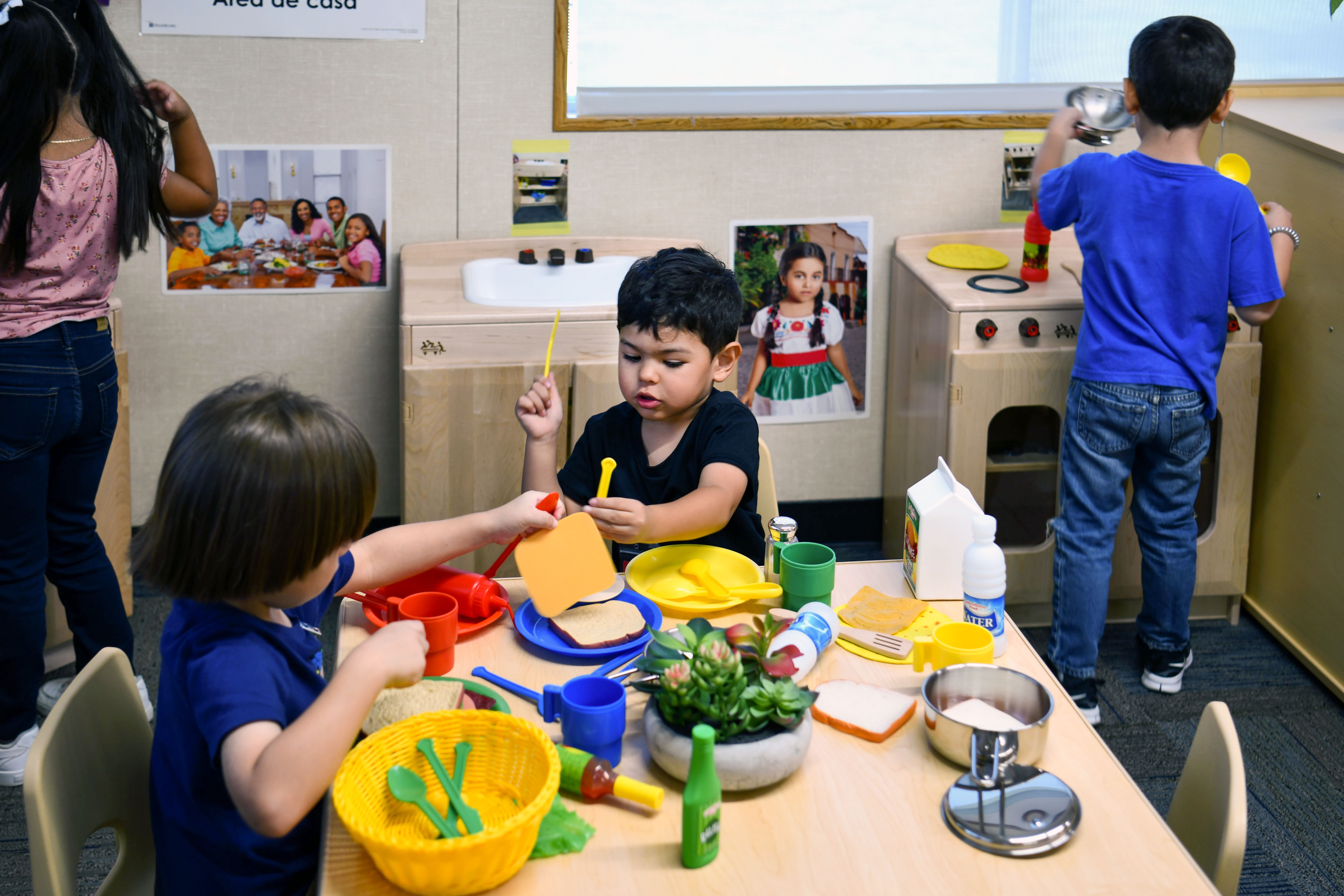 Sunnyslope preschool students play in the home area