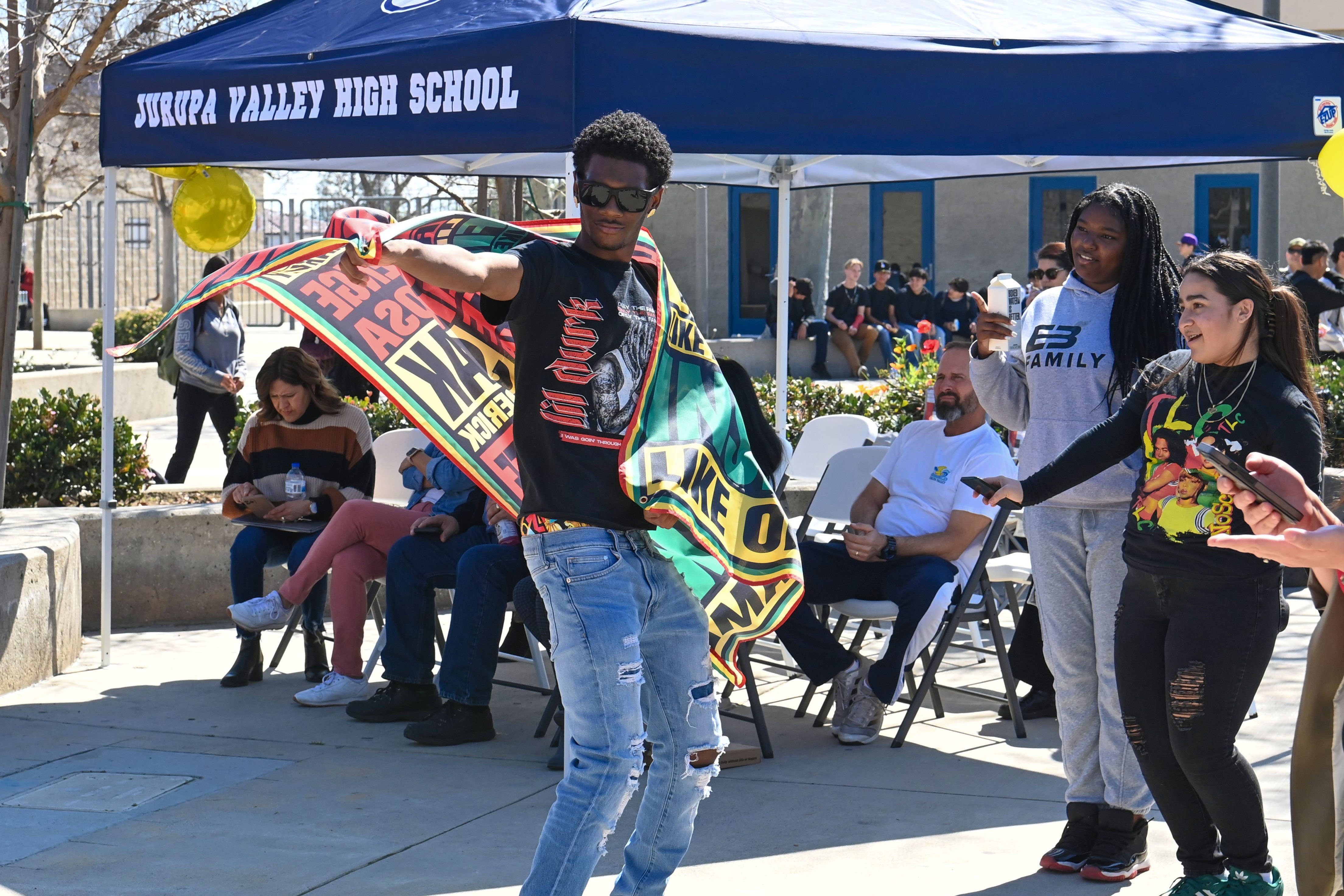 A student enjoying the staff band play during their Black History Month lunchtime celebration 