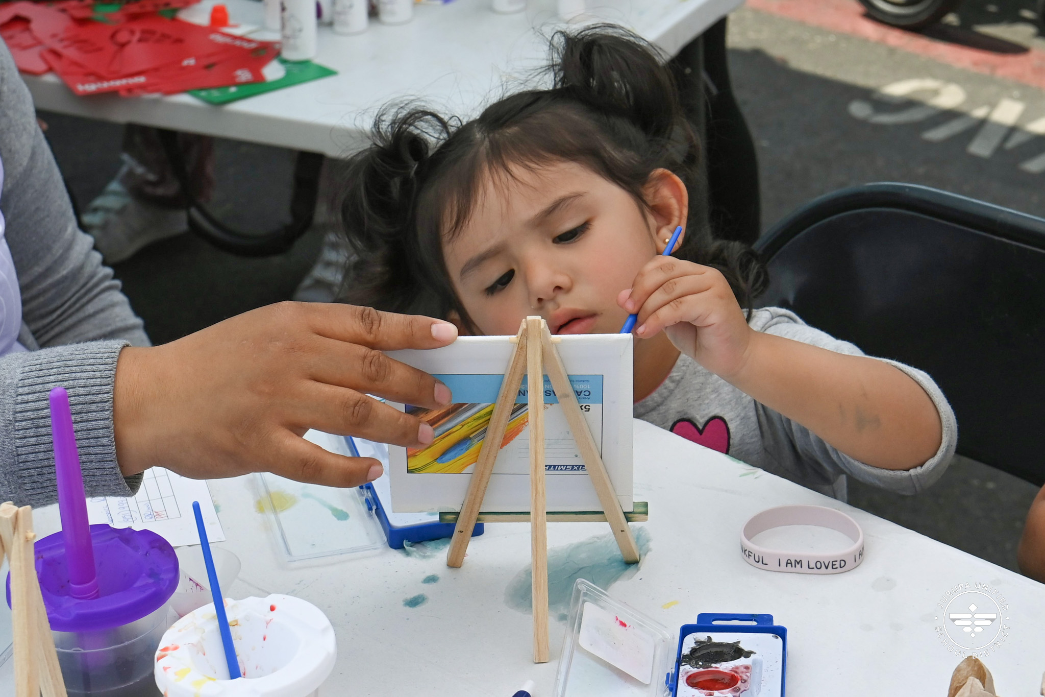 Child painting at the fair