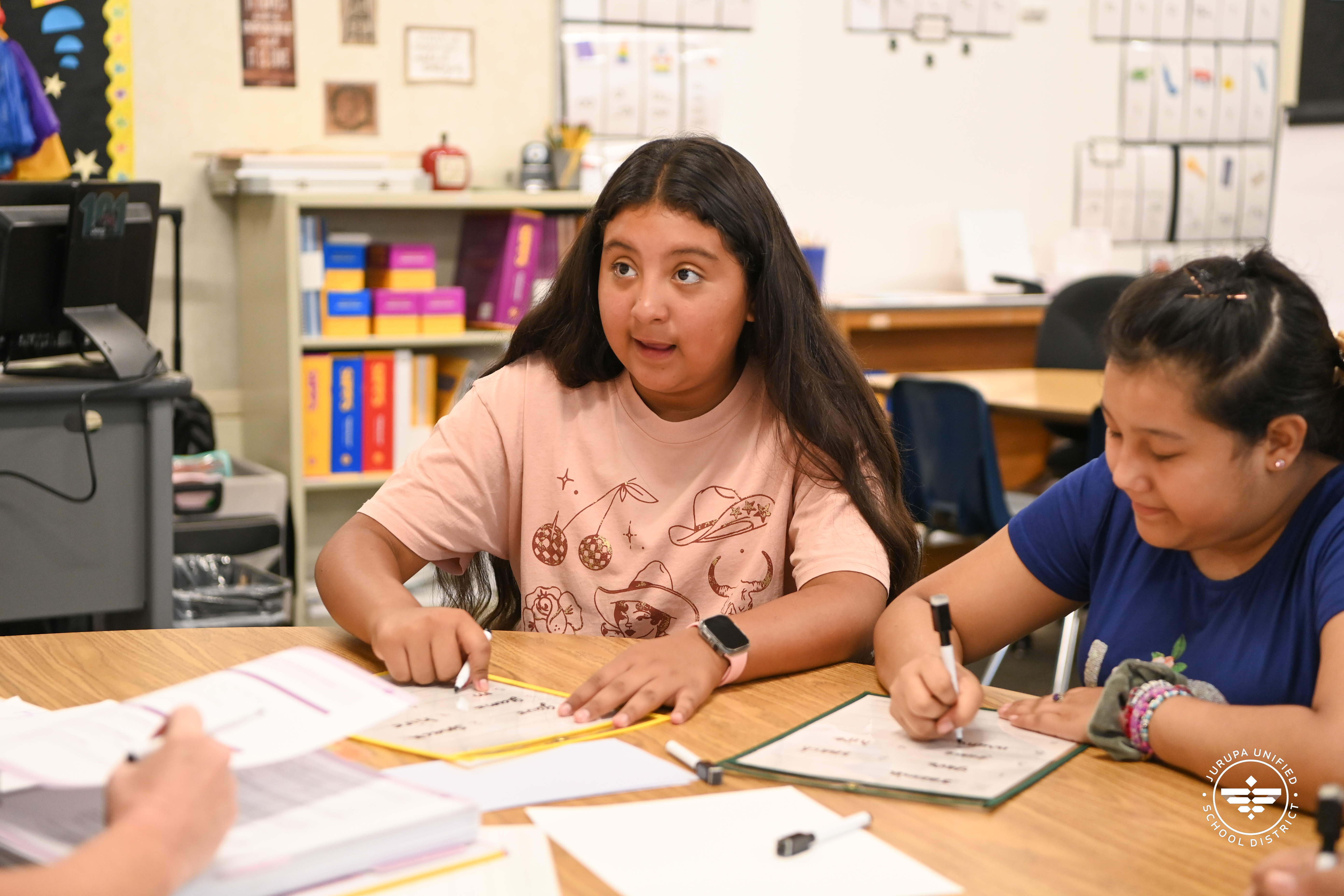 A young student reading with her literacy support group