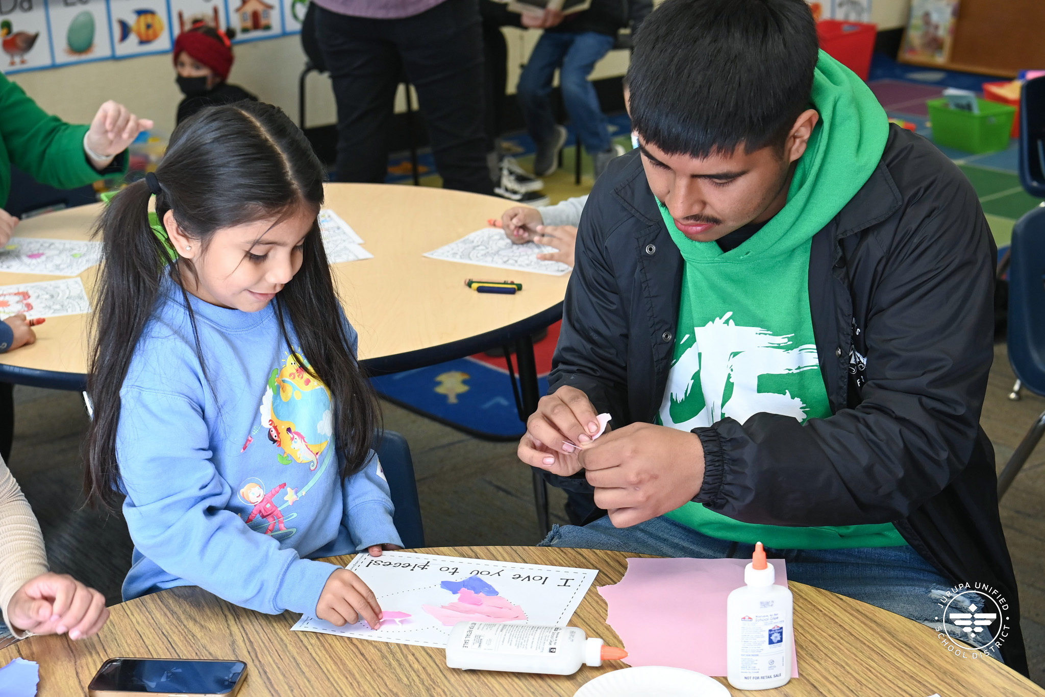 Troth parent completing a craft with child