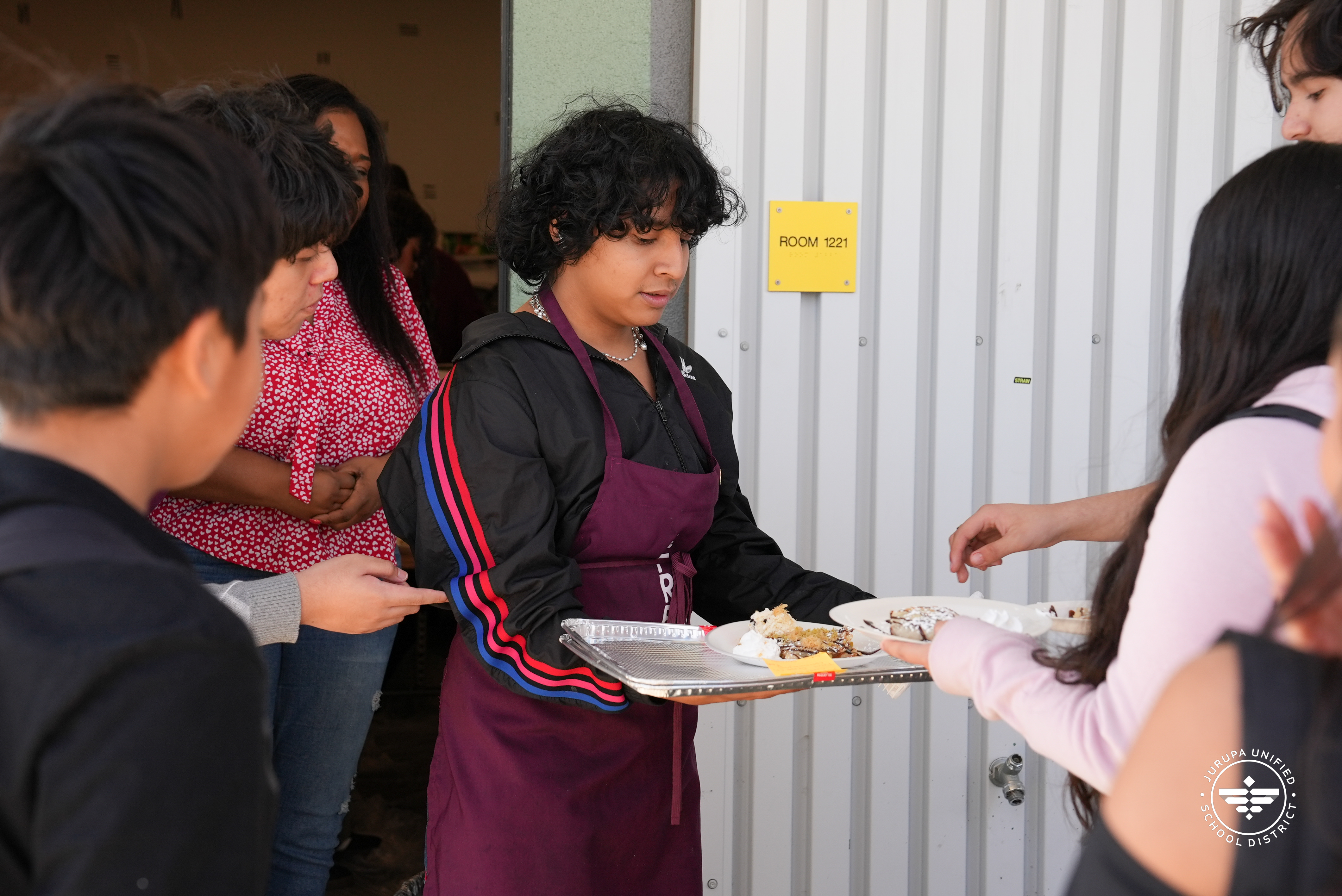 A French Club student handing out crepes during their French Cafe