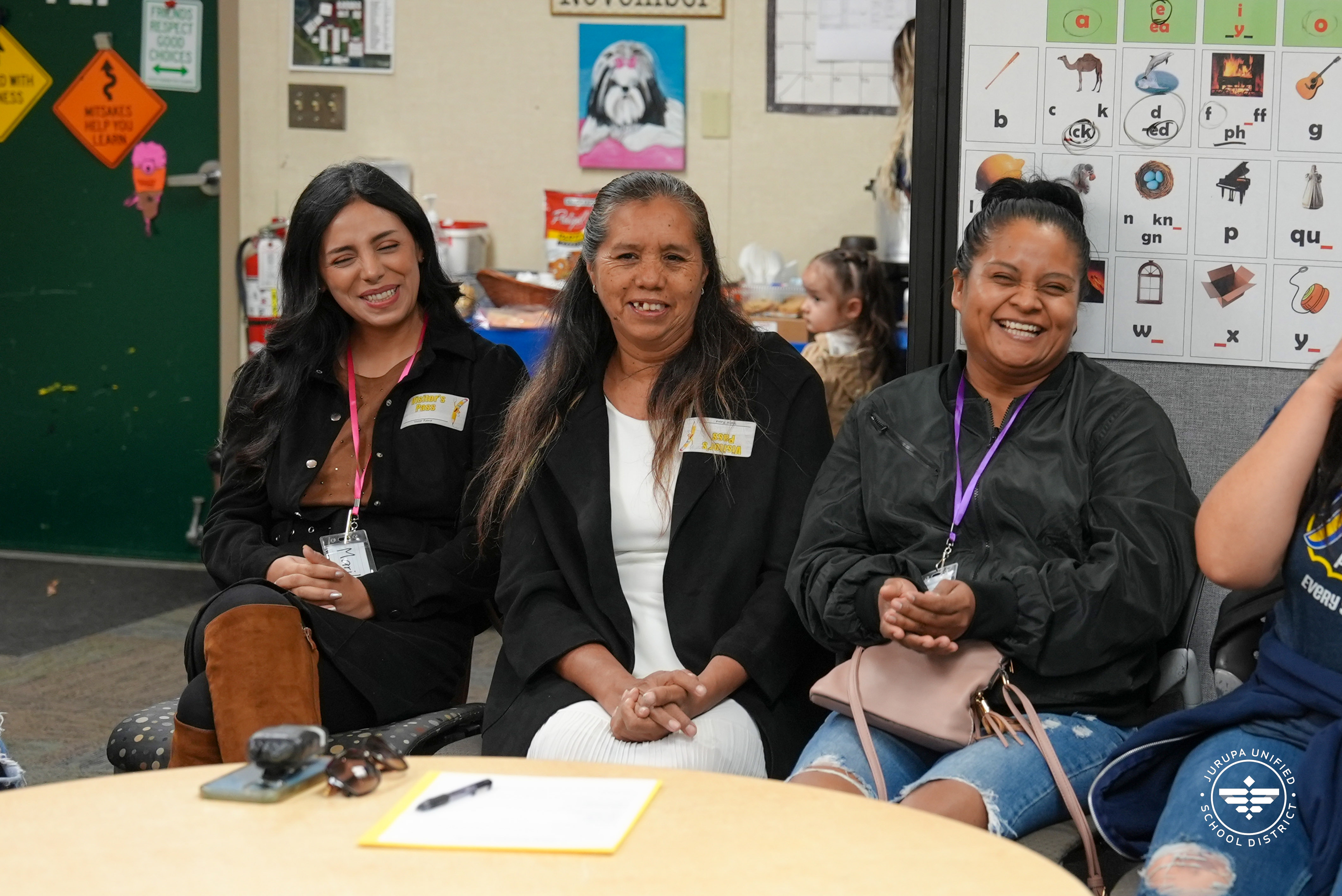 Parents smiling during the Parent University class at Mission Bell Elementary
