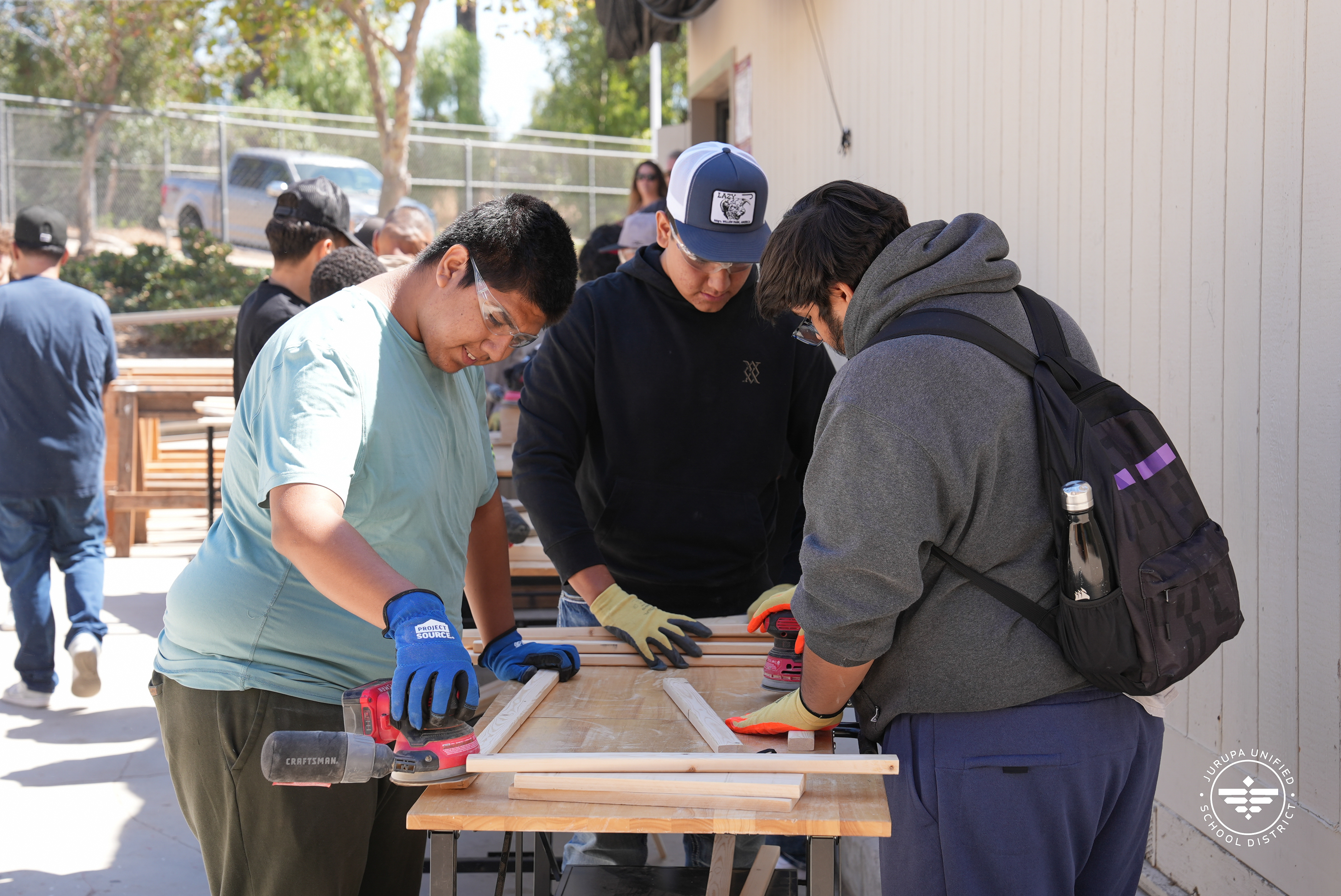 a group of students working on their construction project