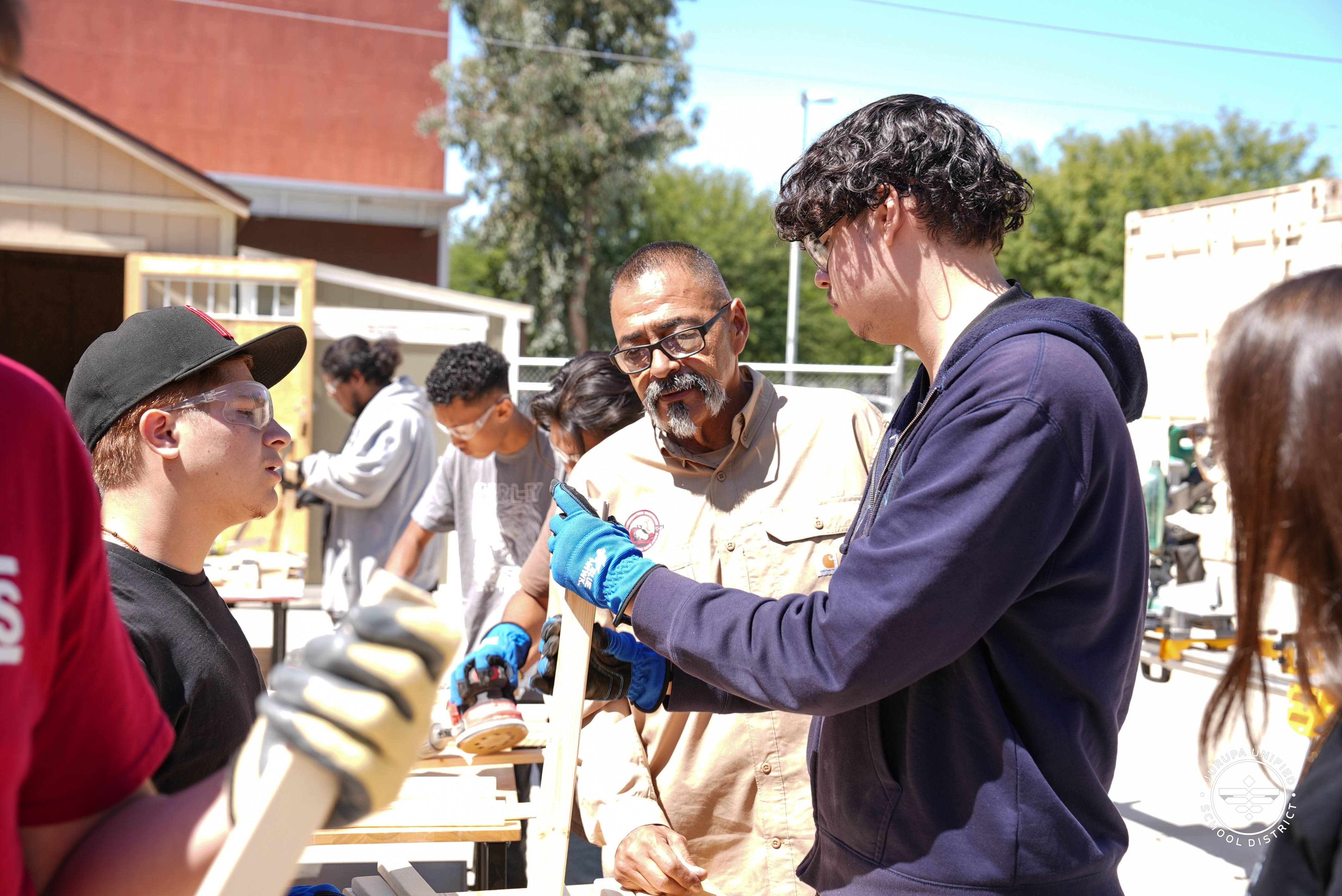 Mr. Martinez helping a student with his construction project