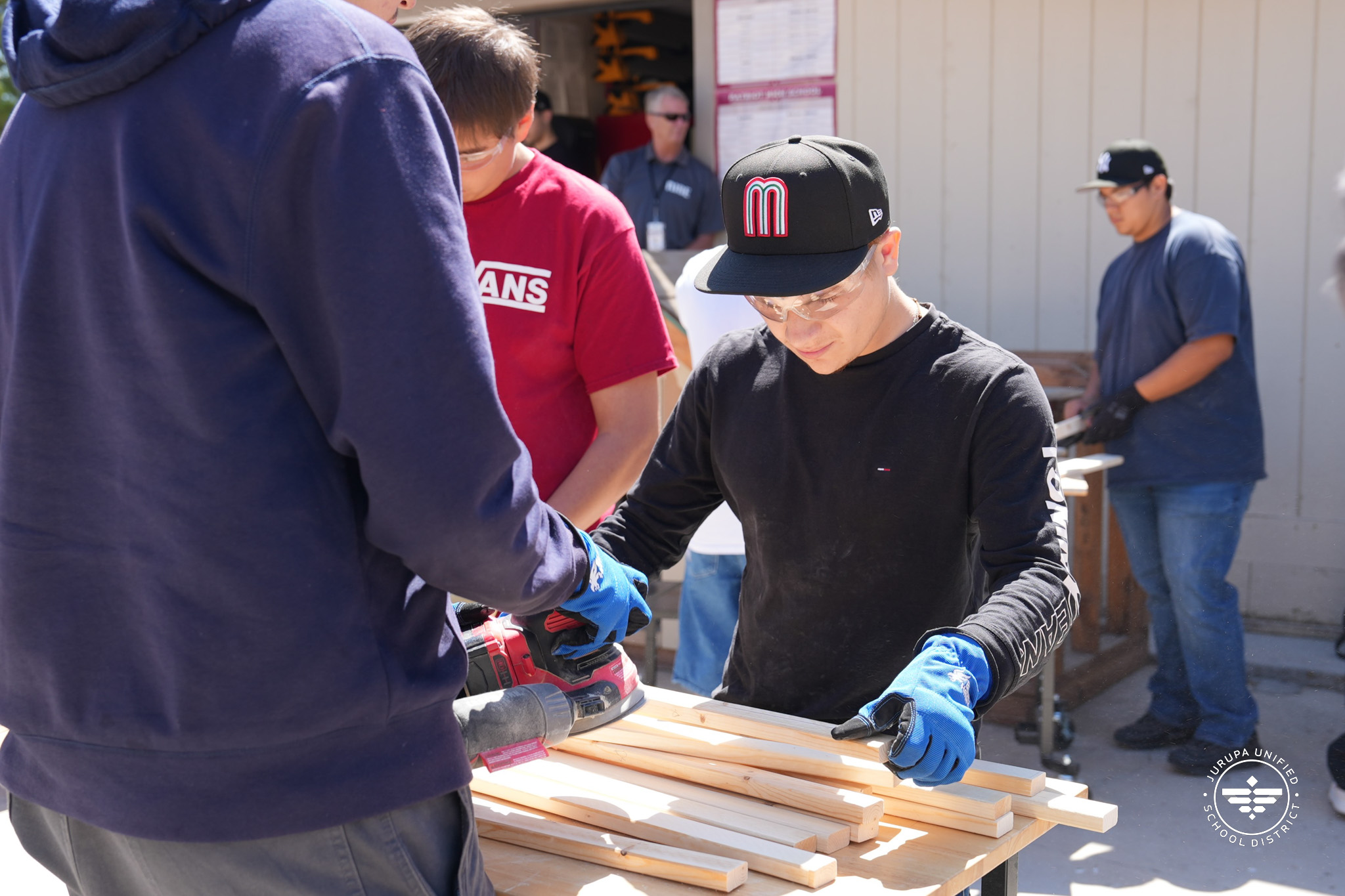 a student working on their construction project with his team mate